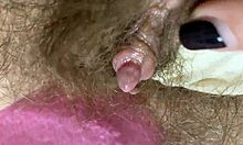 Extreme close-up van een grote clitorispoes die wordt aangeraakt en gespuugd